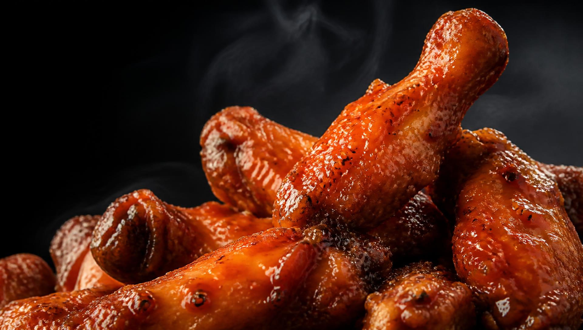 Steaming saucy wings piled high